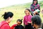 Cute little nomadic children talking to Tenpela Jamyangling as she handed out prayer flags